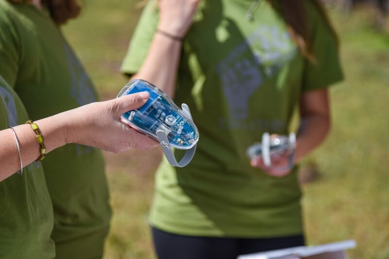 Photo of a hand holding AQ-go air quality sensor.